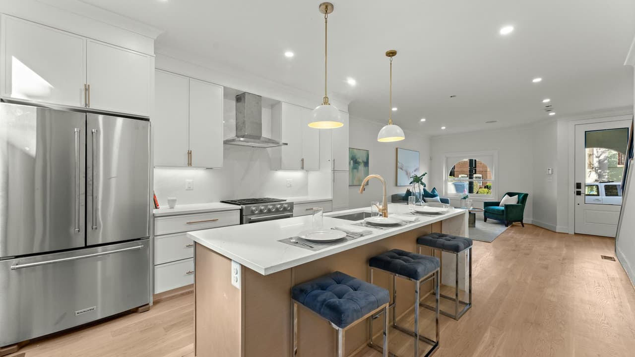 Open-plan Houston kitchen with a stainless French-door refrigerator and gas range